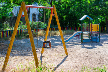 Fototapeta na wymiar A playground with swing and children slides