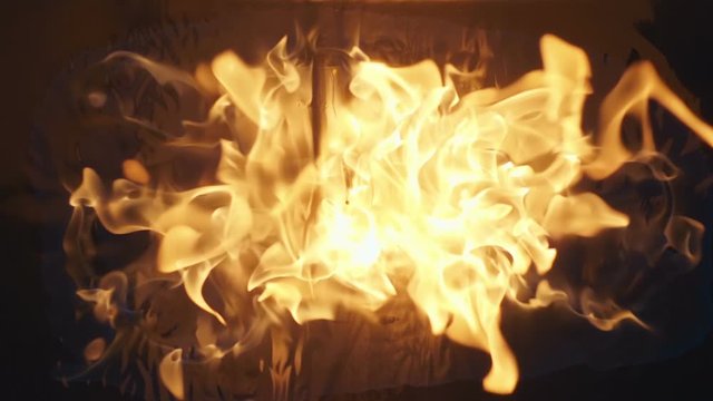 The blue wave of fire slowly spreads from the center, then the fuel flares up with great force and bright flames go up to the camera. Closeup. Slow motion. High speed camera. V-log - High Dynamic Rang