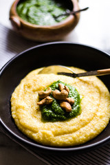 Polenta with cashew pesto on a black ceramic