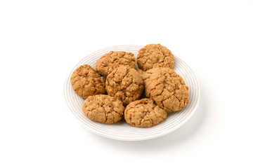 Oatmeal cookies on a white plate isolated on a white background.