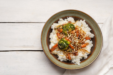 Thai style rice with fried vegetables and soy sauce on white background