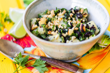 Homemade brazilian tropical salad with banana, herbs and raisins