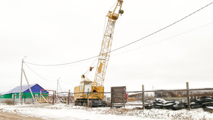 Fototapeta na wymiar construction crane with a raised boom
