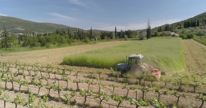 Greece, Larisa - 09 07 2019

Farmer driving his tractor across the earth while drinking coffee