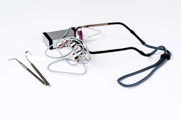 Dental tools and glasses on a white table