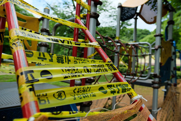 コロナ対策、立ち入り禁止の公園。A playground is caution taped off and closed due to COVID-19. Warning words written in Japanese, Korean, and English.