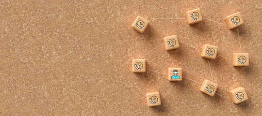 cube-grid with icons symbolizing a conference call on cork background