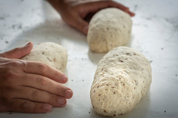 Man kneading a large dough for homemade bread in quarantine