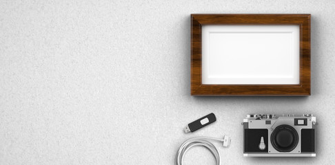 photo camera and empty picture frame on white background