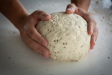 Man kneading a large dough for homemade bread in quarantine