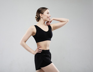 young woman in sportswear posing on a white background, sport concept