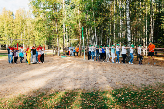 Three team building teams in summer forest
