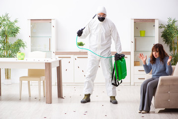 Young male contractor and female client during pest control