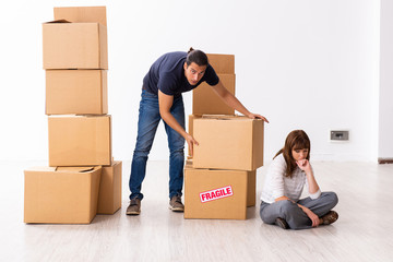 Young pair and many boxes in divorce settlement concept