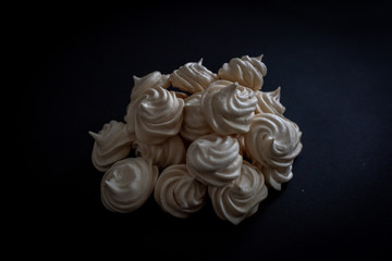 A popular French meringue dessert on a black background. From above.