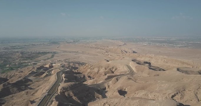 Cars Driving On The Winding Mountain Road In Jebel Hafeet On A Sunny Day In Al Ain, Abu Dhabii, UAE. - aerial drone