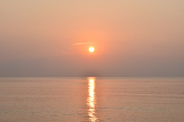 sunrise above the sea. This image is orange