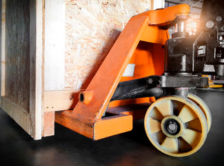 Hand pallet truck with wooden crate. Cargo shipment export, warehouse shipping goods.