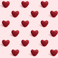 Seamless pattern with dark red polygonal paper heart on pink background. Wallpaper for Valentines Day. Love concept. Bright colors. Minimal style.