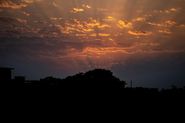 THE SKY BEFORE SUN RISE. SUN RAYS THROUGH CLOUDS 