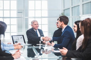business colleagues shaking hands during a work meeting.