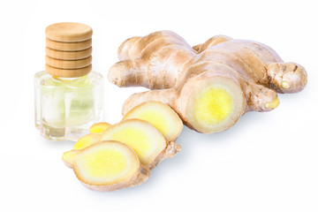 Small glass bottle of extract essential aroma ginger oil with fresh ginger root with slices isolated on white background. Herbal plant concept. 
