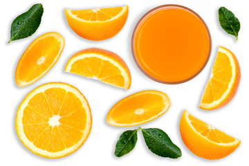 Closeup slices of ripe fresh organic orange fruit with green leaf and glass of orange juice isolated on white background. Top view. Flat lay.