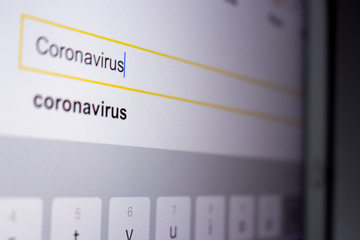 Coronavirus in search bar in search engine on tablet screen.