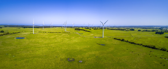 Wind farm and pastures in Australian countryside - aerial panorama - 352384793