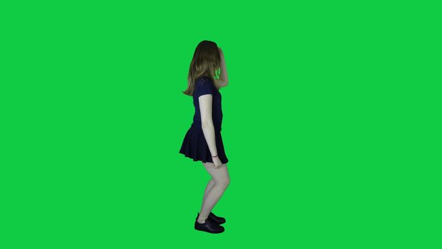 A beautiful female dancing in front of a green screen