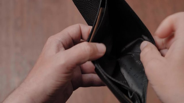 One dollar in an empty businessman purse. Bankruptcy and Poverty Concept, close up