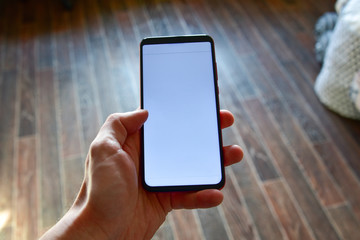 close up man's hand holding mobile phone device with news feed
