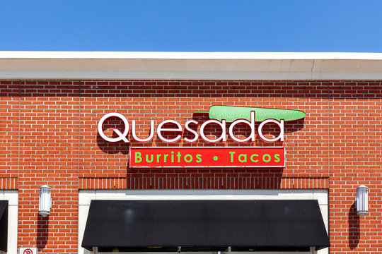 Vaughan, Ontario, Canada - May 23, 2020: Quesada Burritos & Tacos restaurant sign above the entrance; Quesada is a Canadian-owned Mexican restaurant chain