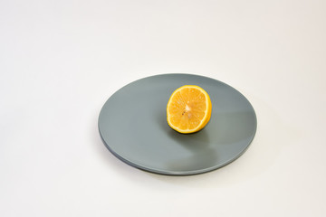 sliced lemon on a plate on a white background