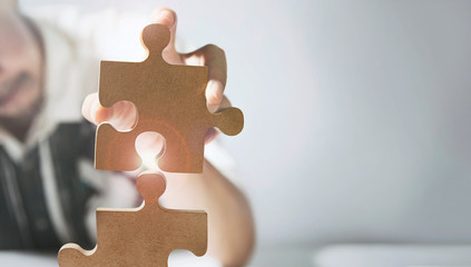 Businessmen connect jigsaws with new marketing strategies