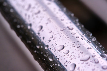 drops of water on the iron pipe macro color