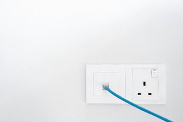 Power socket and Internet socket. Socket Malaysian type. Socket with switch on a white wall.
