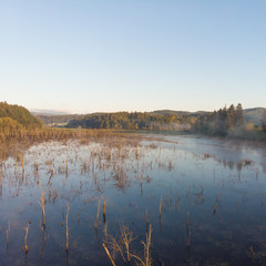 Morning lake with steam at sunrise, morning landscape. Shot from a height