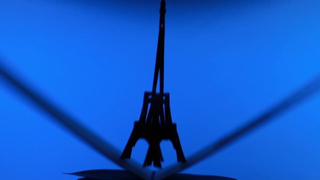 Opening Paper Eiffel Tower Pop Up Three-Dimensional 3D Greeting Card On A Blue Background.