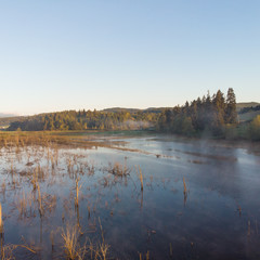Morning lake with steam at sunrise, morning landscape. Shot from a height