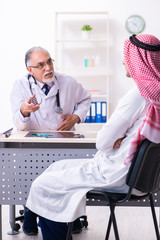 Young male arab visiting experienced male doctor