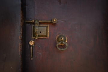 Old black wooden door with gold antique handle. Details Classic vintage doors of the interior element.