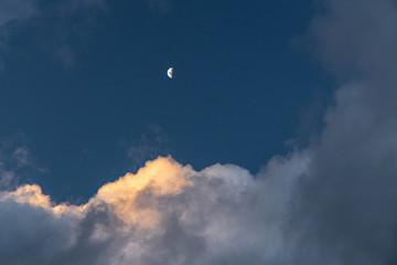 Moon over sunset clouds