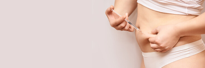 Person injecting stomach medicine treatment. Diabet or hormone injection. Abdomen disease...