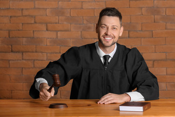 Male judge at table in courtroom