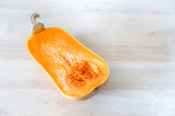 Raw butternut squash pumpkin vegetable or Butternut Pumpkin cut on a wood board background