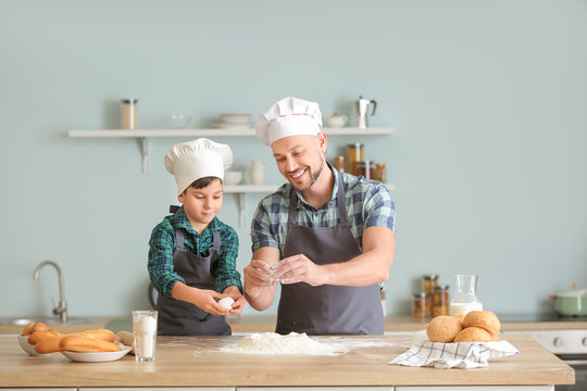 Father and his little son cooking in kitchen