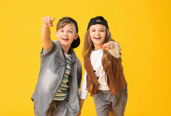 Cute little children dancing against color background