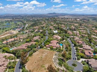 Fototapeta na wymiar Aerial view of high class neighborhood with big residential mansions with swimming pool in the green valley, Pacific Highlands Ranch, San Diego, California, USA.