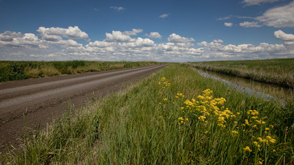 floating spring clouds on a blue sky in a partly cloudy sky over the steppe and river